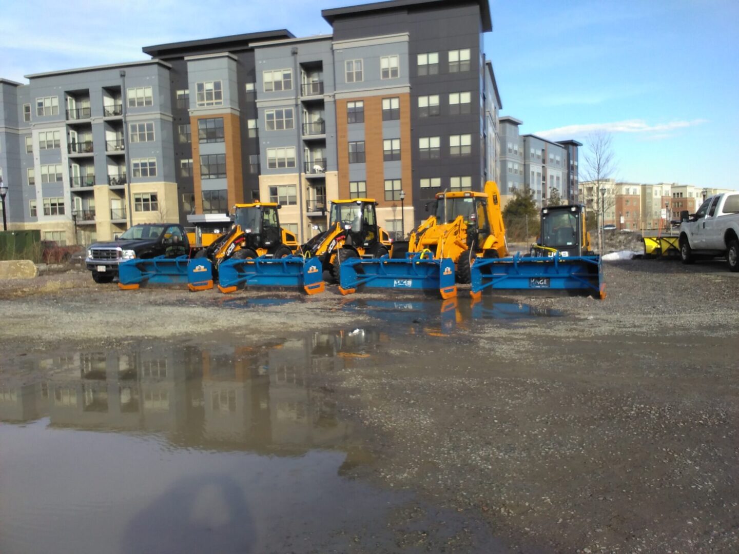 A group of construction equipment parked in the street.